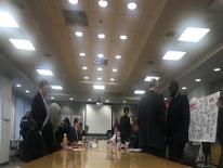 Attendees standing at conference table